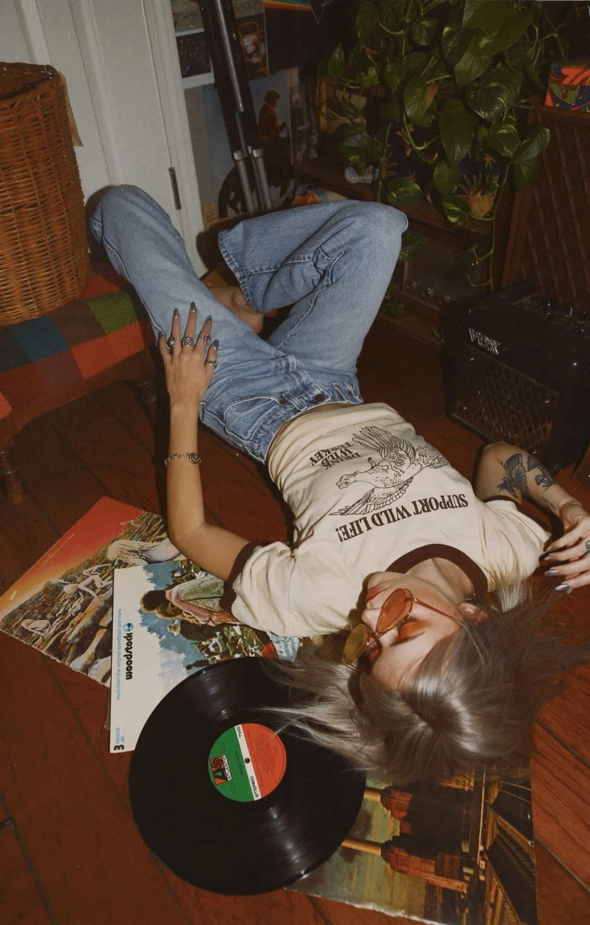 candid girl listening to vinyl music laying on the floor