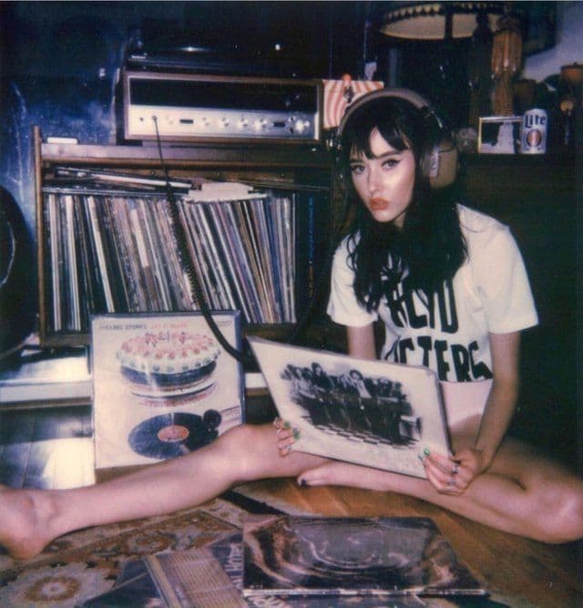 candid girl listening to music in her living room