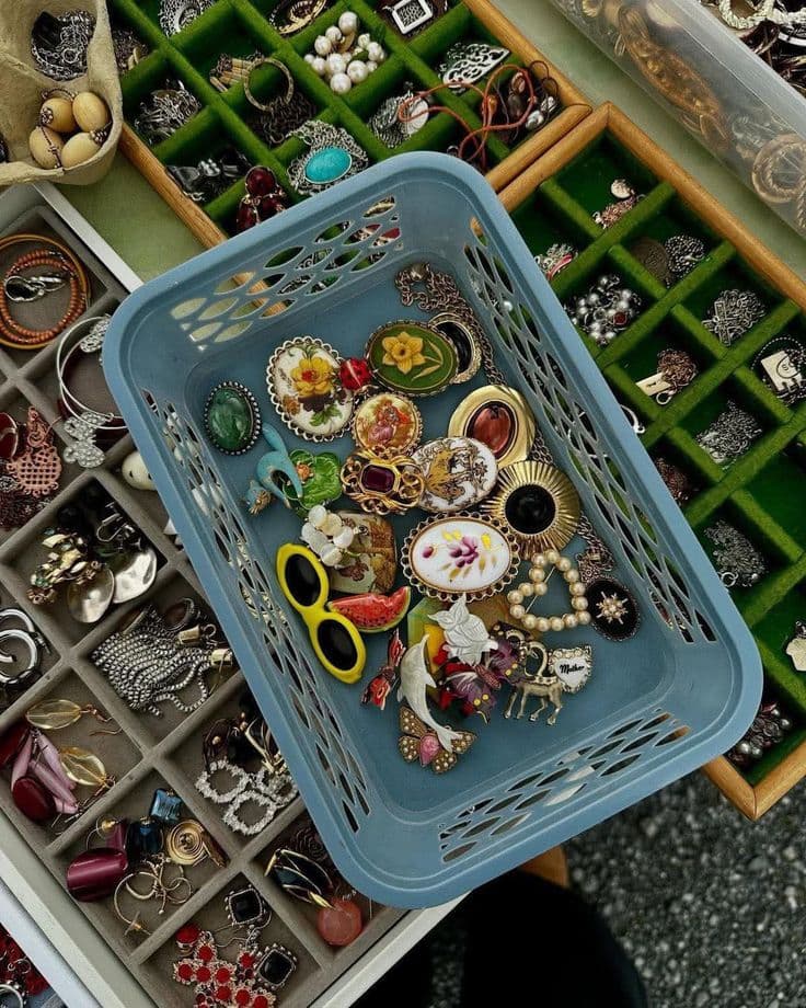 vintage jewellry in a blue plastic container