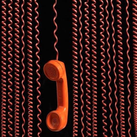 vintage orange telephone hanging